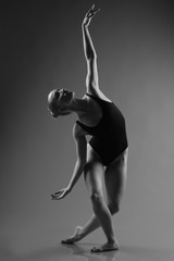 Naklejka premium Modern ballet dancer posing on dark background