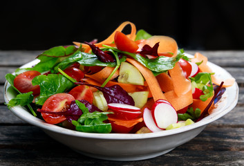Fresh Vegetable salad on old wooden table.