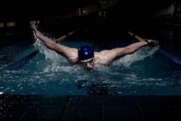 Sportsman swims in a swimming pool