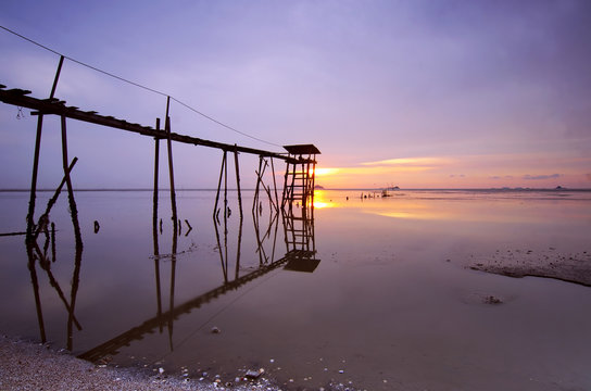 old bridge at jeram beach during sunset