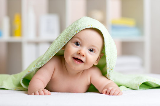 Smiling Baby After Shower Or Bath With Towel On Head 