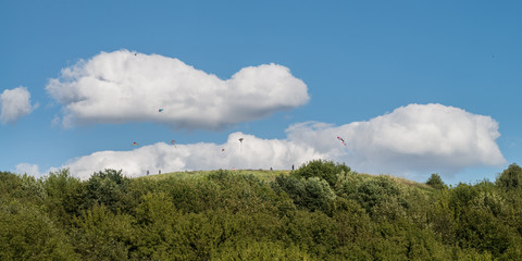 People flying kites atop the Drachenberg in Berlin Grunewald