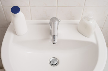Clean sink and chrome faucet in a bathroom