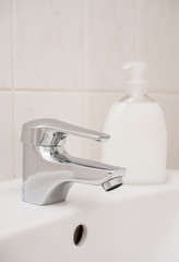 Clean sink and chrome faucet in a bathroom