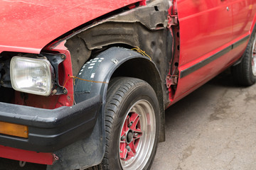 Damaged red car without body parts