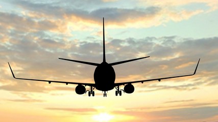 Modern Passenger airplane silhouette flight in sunset