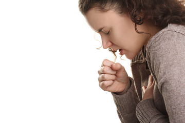 girl in a sweater with a cough on a white isolated background