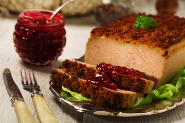 Homemade meat pie with vegetables, served with cranberry sauce