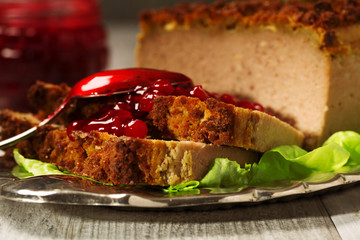 Homemade meat pie with vegetables, served with cranberry sauce