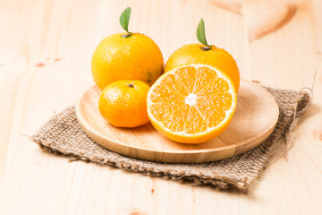 slice orange fruit on wood plate