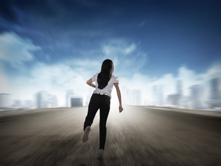 Back view of business woman running