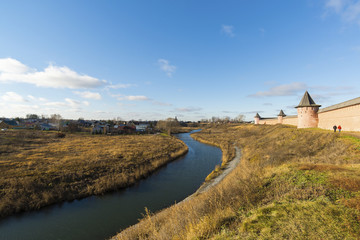 Fototapeta premium Landscape with river Kamenka and Wall St. Euthymius monastery in Suzdal, Russia. Golden Ring of Travel