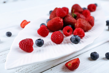 Tasty ripe berries on wooden table close up