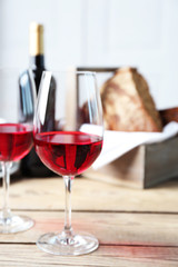 Still life of wine and bread on light background