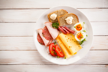 Breakfast - boiled egg, bacon, cheese and vegetables 