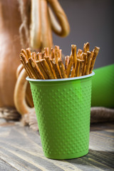 Disposable green cup containing straws