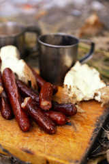 Grilled sausages on cutting board in the wood