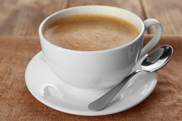 Cup of coffee on sackcloth napkin closeup