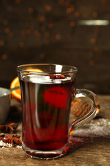 Christmas composition of mulled wine, cinnamon and stew-pan on wooden table