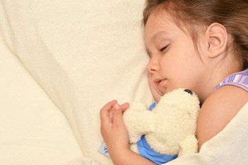 Little girl sleeping with a toy