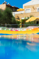 Swimming pool with inflatable raft in tropical resort.