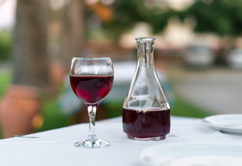 Glass of red wine and bottle in a restaurant.