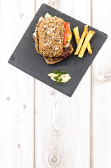 Burger with cheese, tomato, lettuce and chips