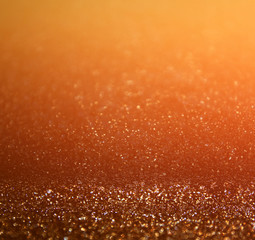 glitter vintage lights background. dark gold and black. defocused
