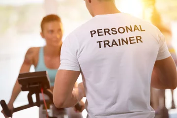  Personal trainer on training with  client © luckybusiness