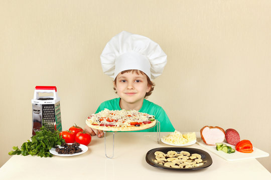 Little Funny Chef In Chefs Hat Preparing A Pizza