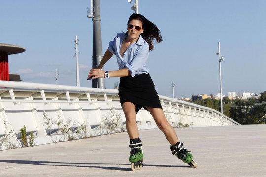 woman skater speeding to the right with a skirt