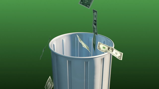 Money Fall in Trash Can. Camera rises up as money falls into trash can on a green background. luma matte for easy isolation
