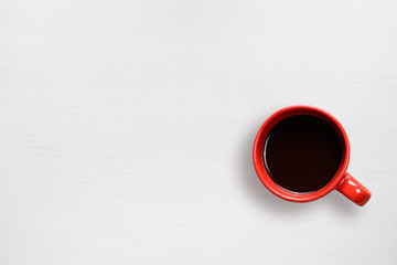 Red coffee cup on white table top view