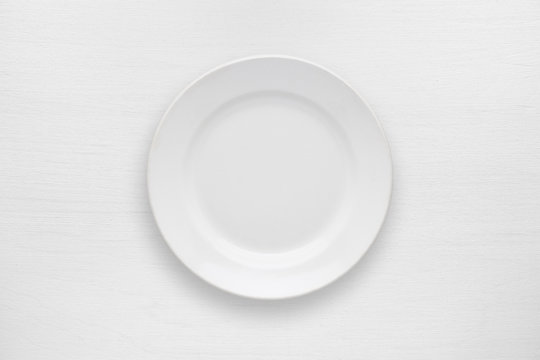 Empty plate on white table top view