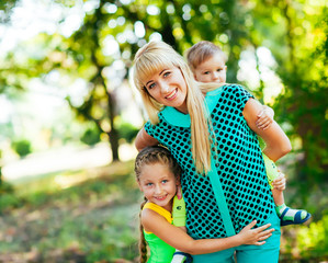 Fototapeta premium Happy young family, mother and childrens together having fun out