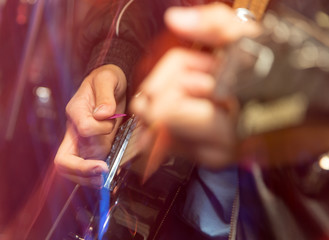 aggressive play guitar on stage