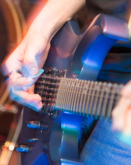 aggressive play guitar on stage