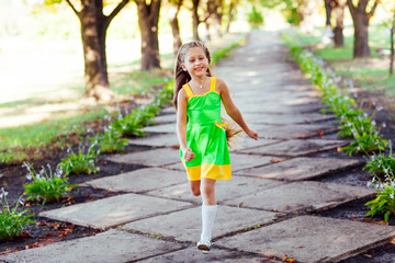 little girl running in the park. Happiness.