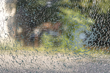 Broken window with a bullet hole in the middle