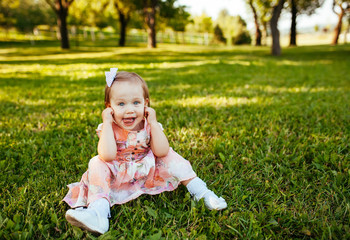 Cute little girl on the meadow in summer day.
