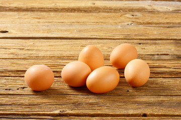 Brown eggs on wooden surface