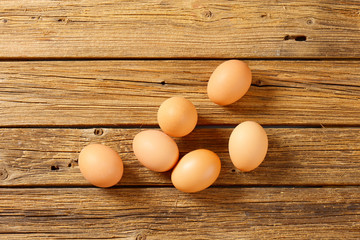 Brown eggs on wooden surface