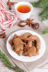 gingerbread cookies on a plate, surrounded with spices, tea, car