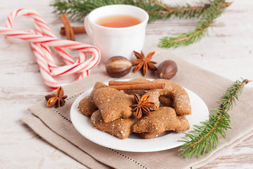 homemade gingerbread cookies on a plate, surrounded with spices,
