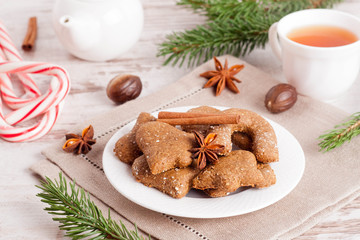 homemade gingerbread cookies, surrounded with spices, tea, caram