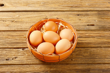 Brown eggs in terracotta bowl