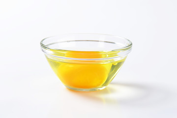 Egg white and yolk in glass bowl