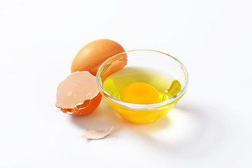 Egg white and yolk in glass bowl