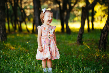 Outdoor portrait of adorable smiling little girl in summer day
