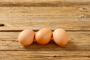 Brown eggs on wooden surface